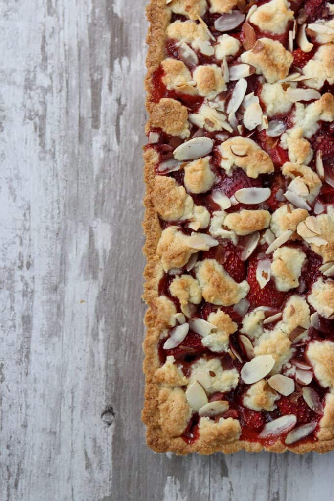 Strawberry almond tart on a wooden surface