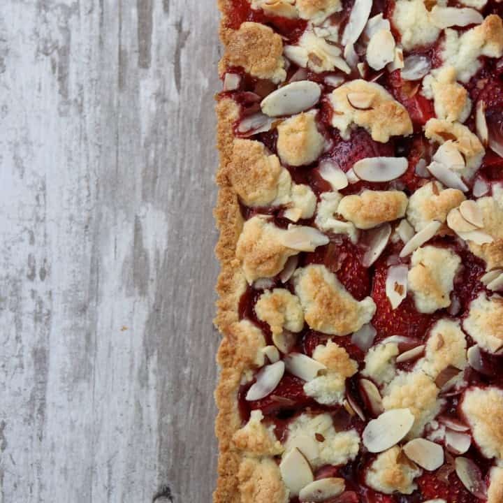 Strawberry almond tart on a wooden surface
