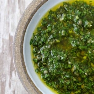 A close up of a bowl of fresh herb sauce
