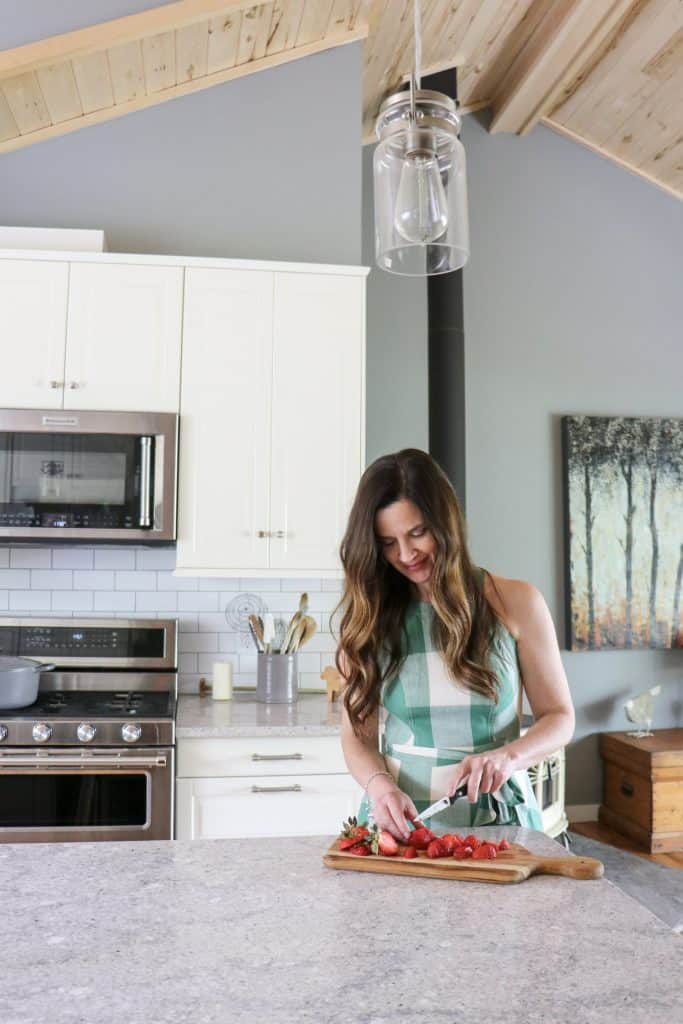 Kristi Bissell chopping strawberries in her kitchen