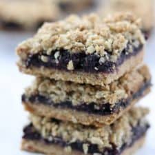 A close up of a stack of blueberry crumble bars