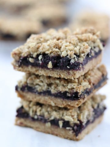 A close up of a stack of blueberry crumble bars