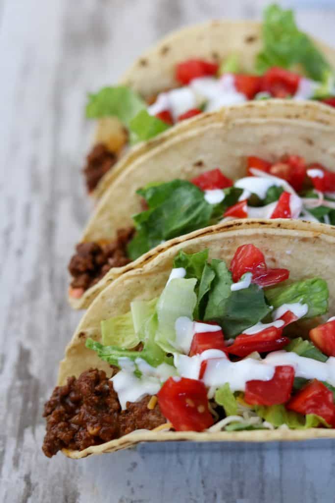 A close up of tacos with toppings