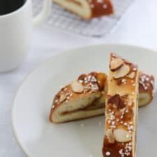 Nordic apple strips piled on a plate with a cup of coffee