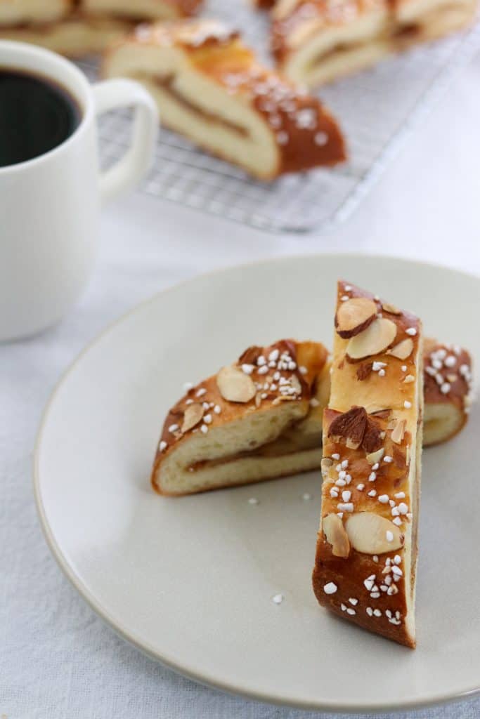 Nordic apple strips piled on a plate with a cup of coffee