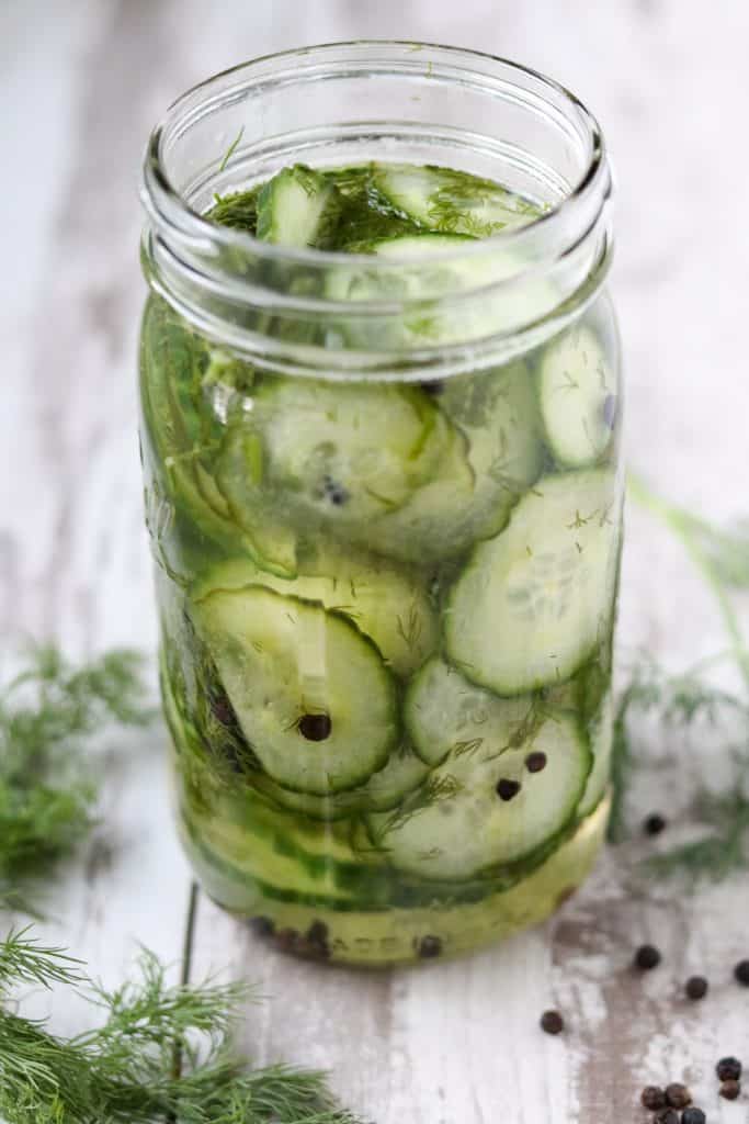 A close up of fresh pickled cucumbers in a jar