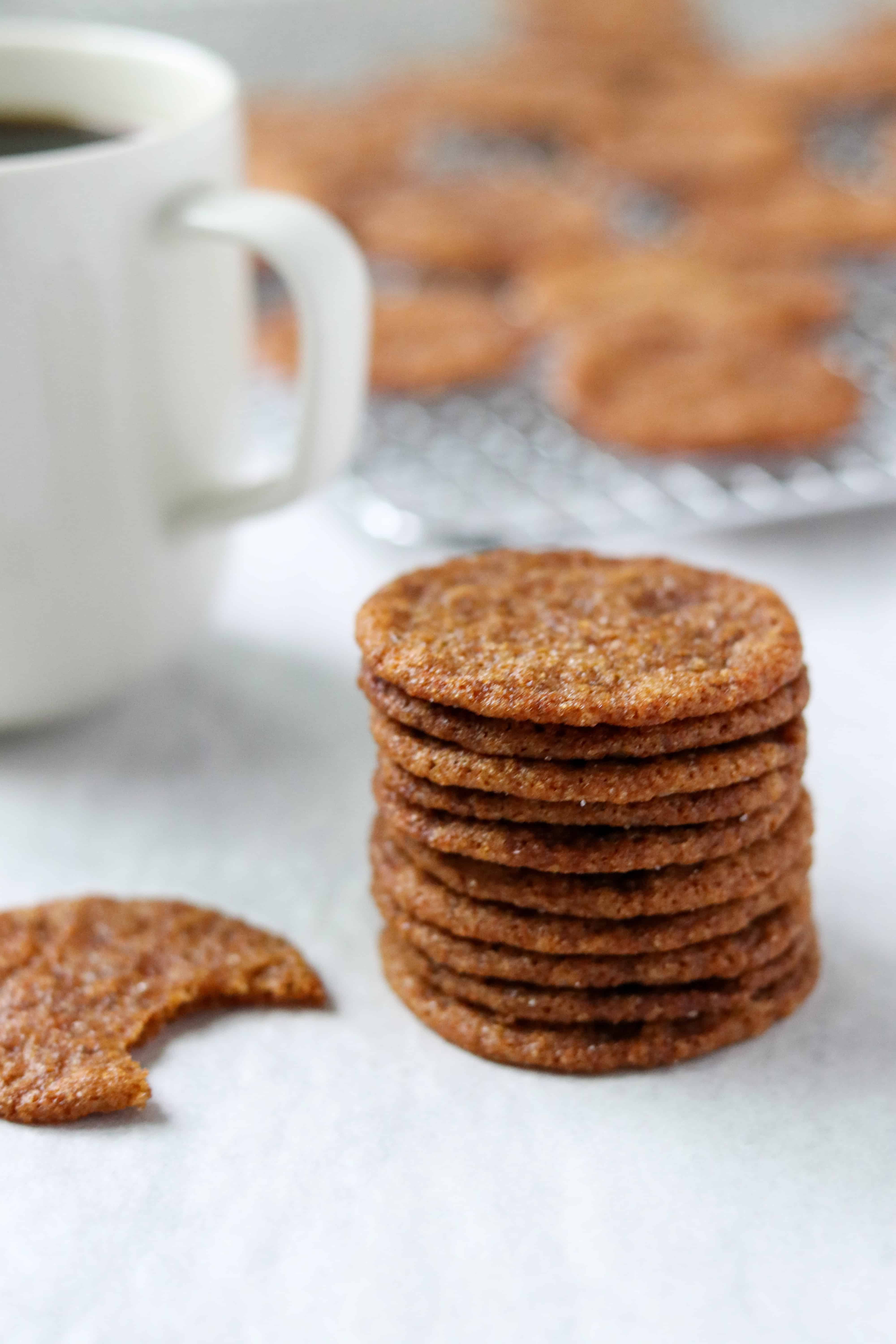 A close up of a stack of Swedish ginger snaps and a cup of coffee