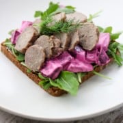 An open sandwich with meatballs and beet salad on a plate