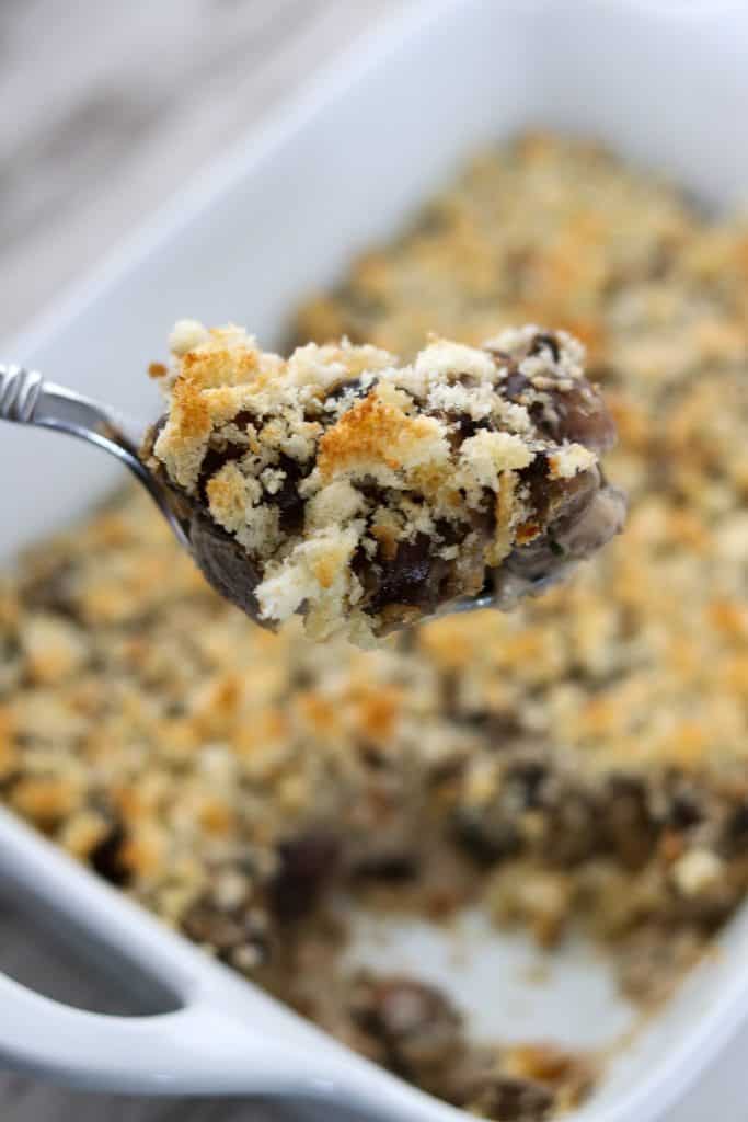 A close up of mushroom gratin on a spoon