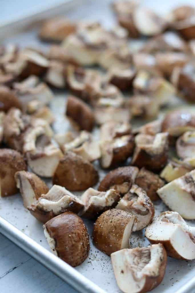 A close up of quartered mushrooms