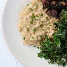 Barley risotto, roasted mushrooms and kale on a plate