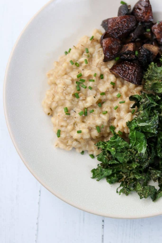 Barley risotto, roasted mushrooms and kale on a plate