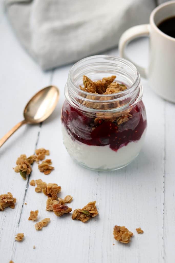 Skyr yogurt, beets, raspberry and granola in a jar with a spoon
