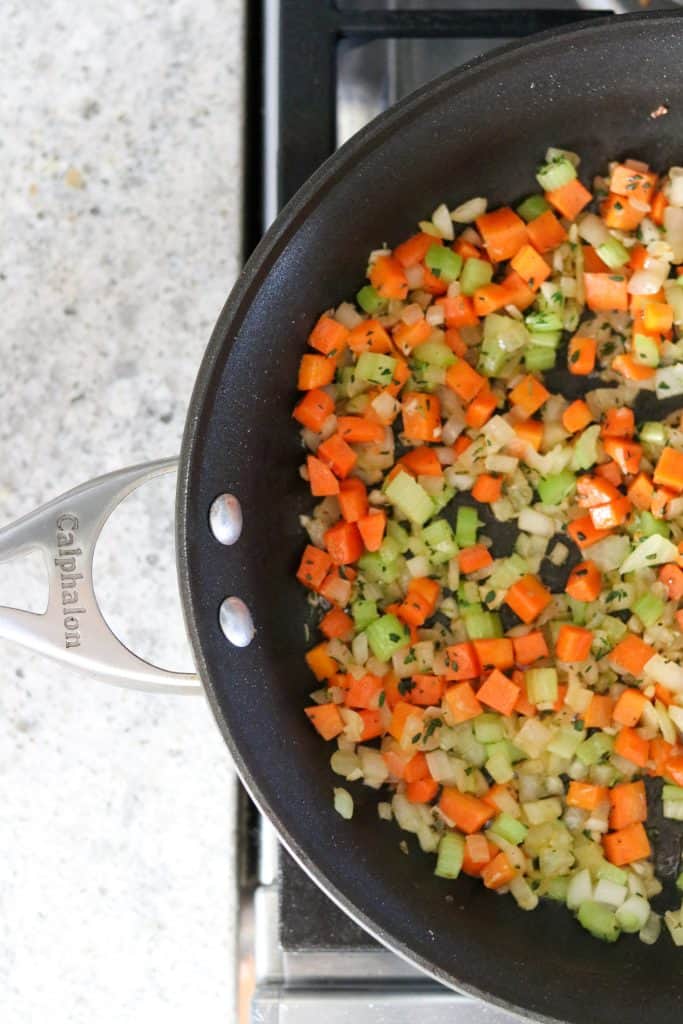 Onions, carrots, celery and garlic cooking in a pan