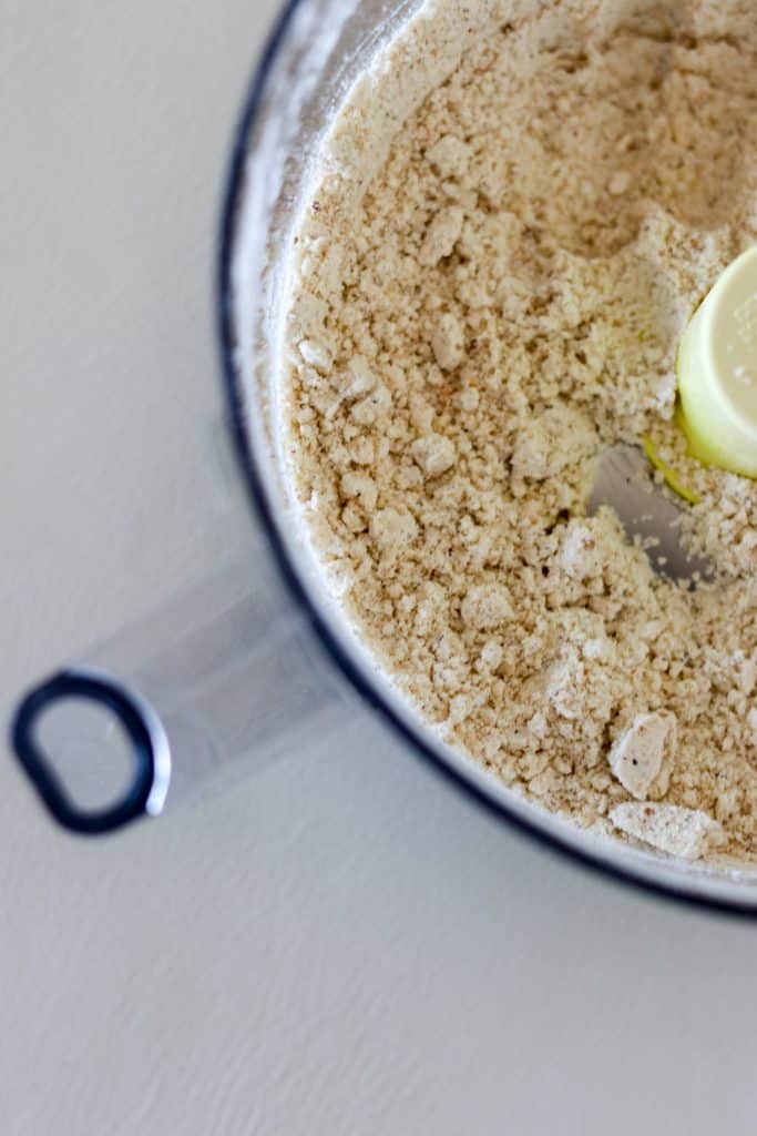 Flour and ground hazelnuts in a food processor work bowl