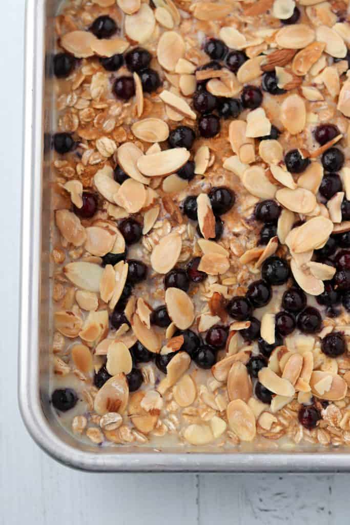 Unbaked oat and rye porridge with almonds and blueberries in a pan