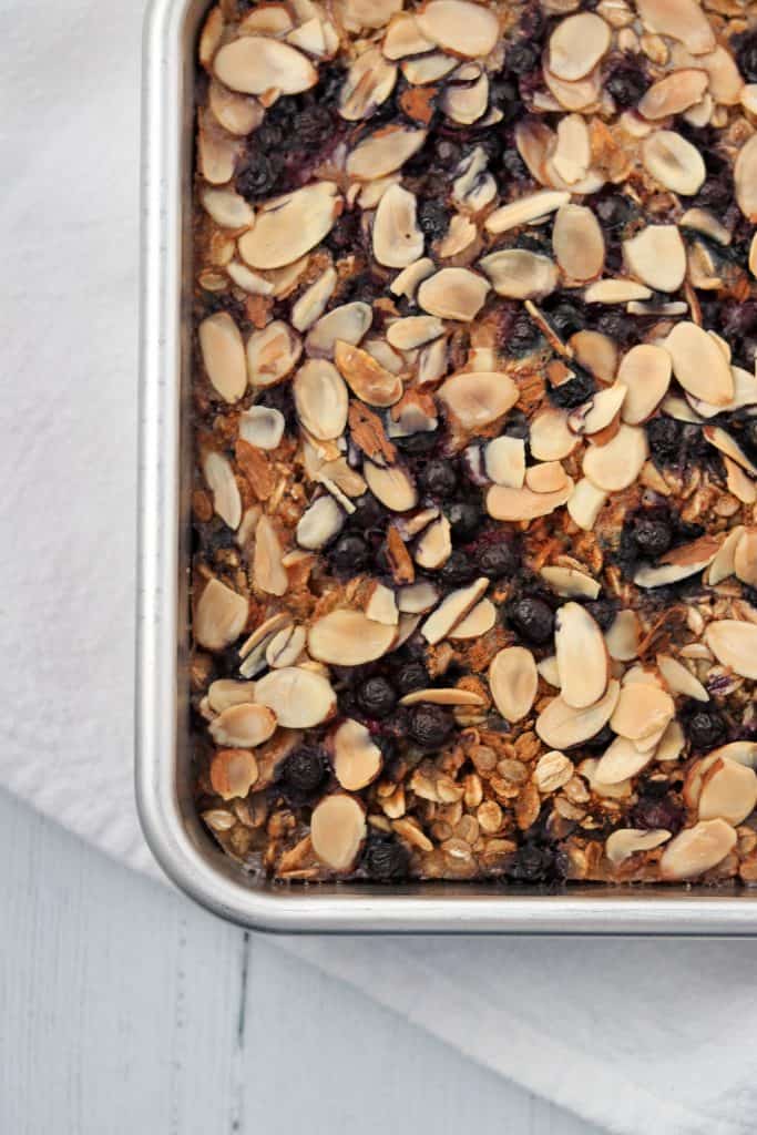 Baked oat and rye porridge with blueberries and almonds in a pan