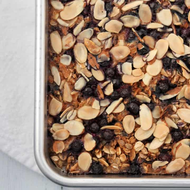 Baked oat and rye porridge with blueberries and almonds in a pan
