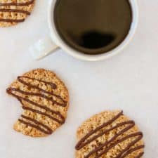 Oat cookies drizzled with chocolate and a cup of coffee
