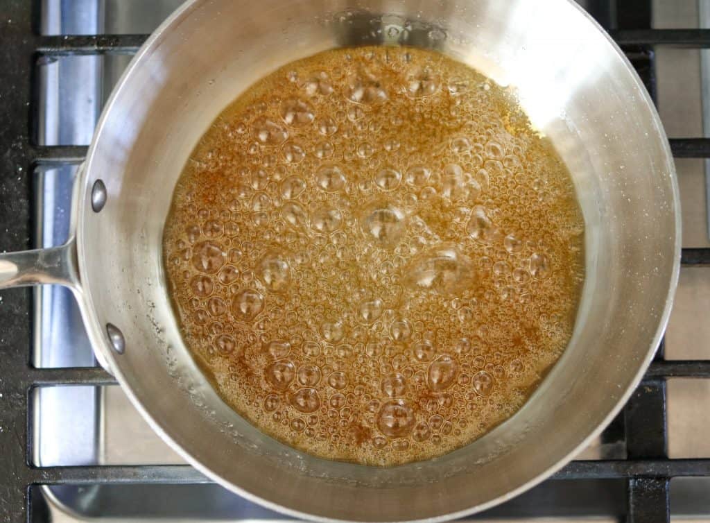 A close up of a saucepan with caramel sauce