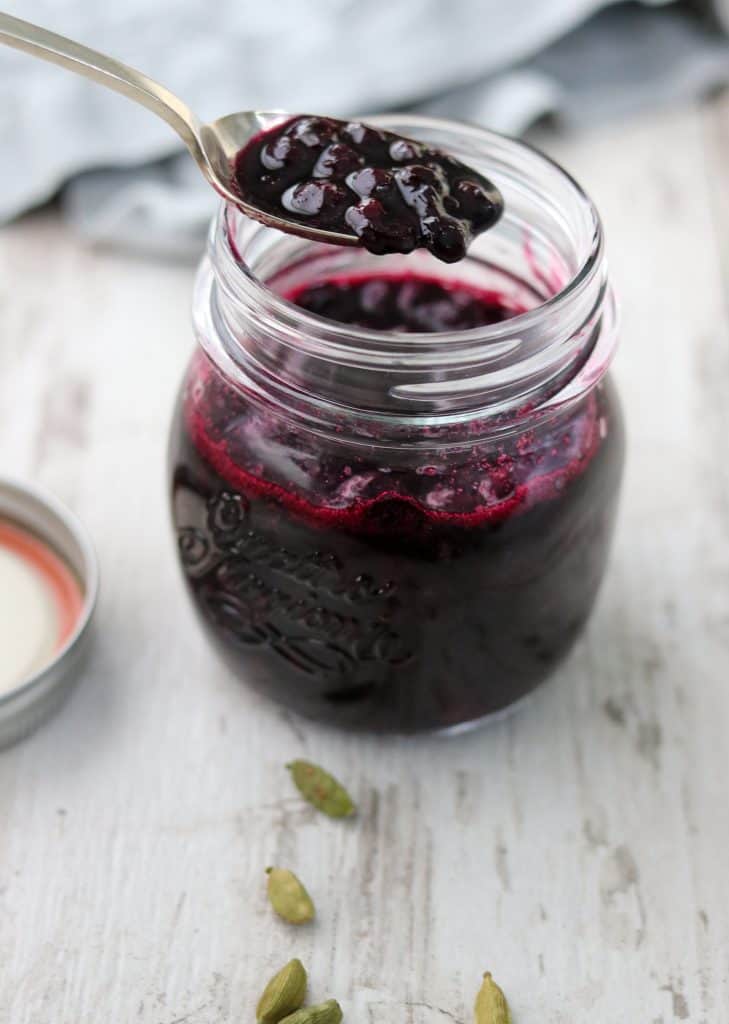 Blueberry compote in a jar with a spoon