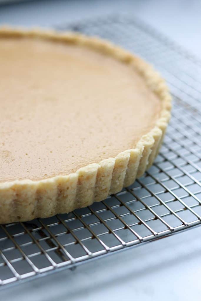 A close up of a brown sugar skyr tart on a cooling rack