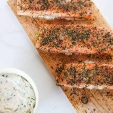 Salmon filets on a cedar plank with a creamy sauce