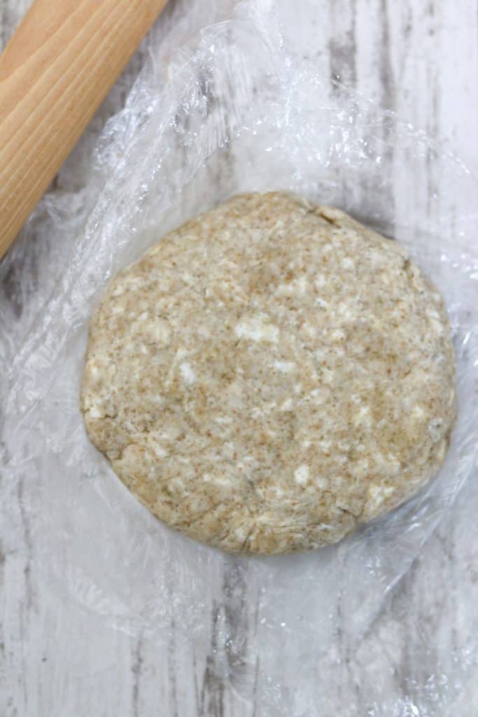 Chilled galette dough round and plastic wrap