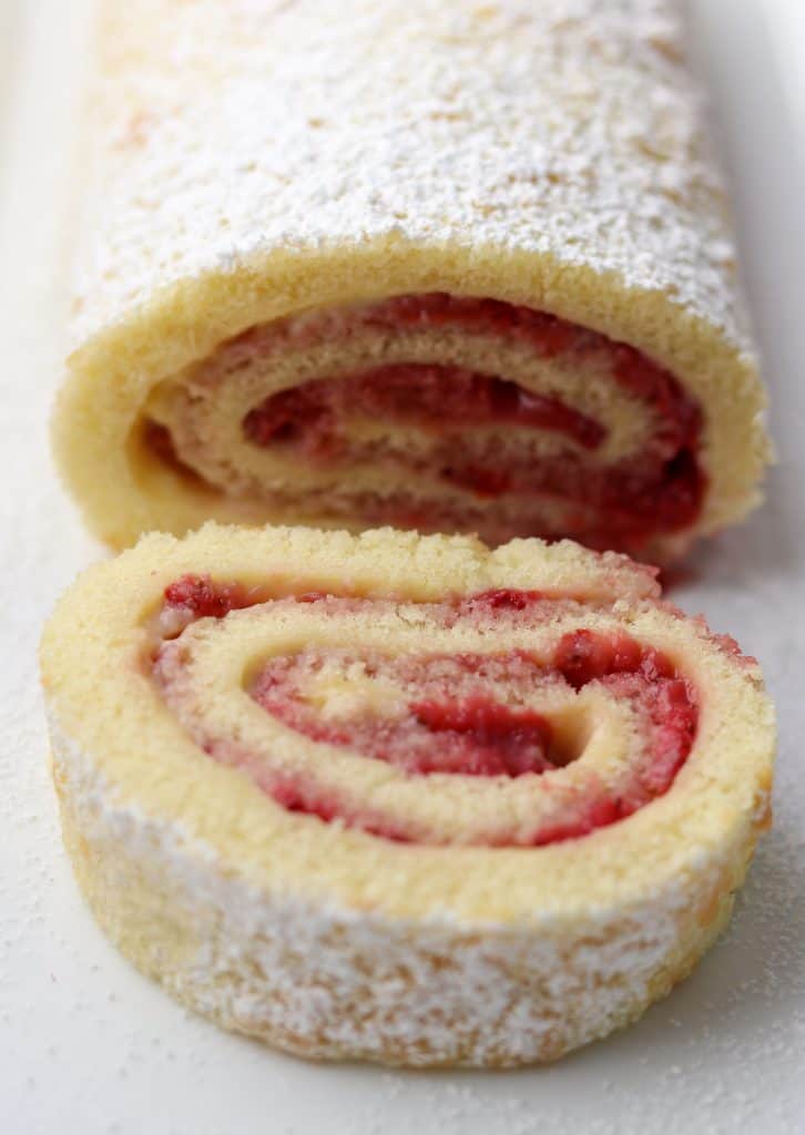 A close up of a slice of strawberry rolled cake