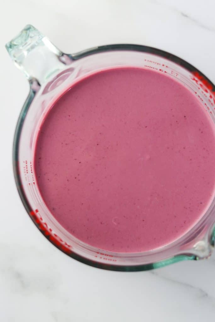 Frozen berry yogurt mixture in a measuring cup