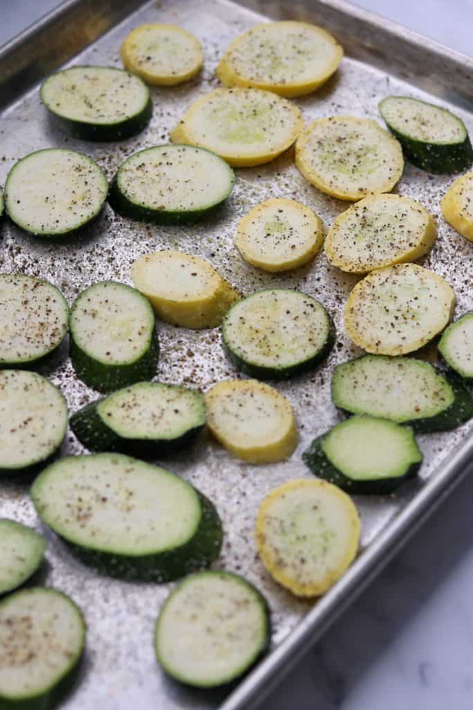 Zucchini and summer squash slices on a baking sheet