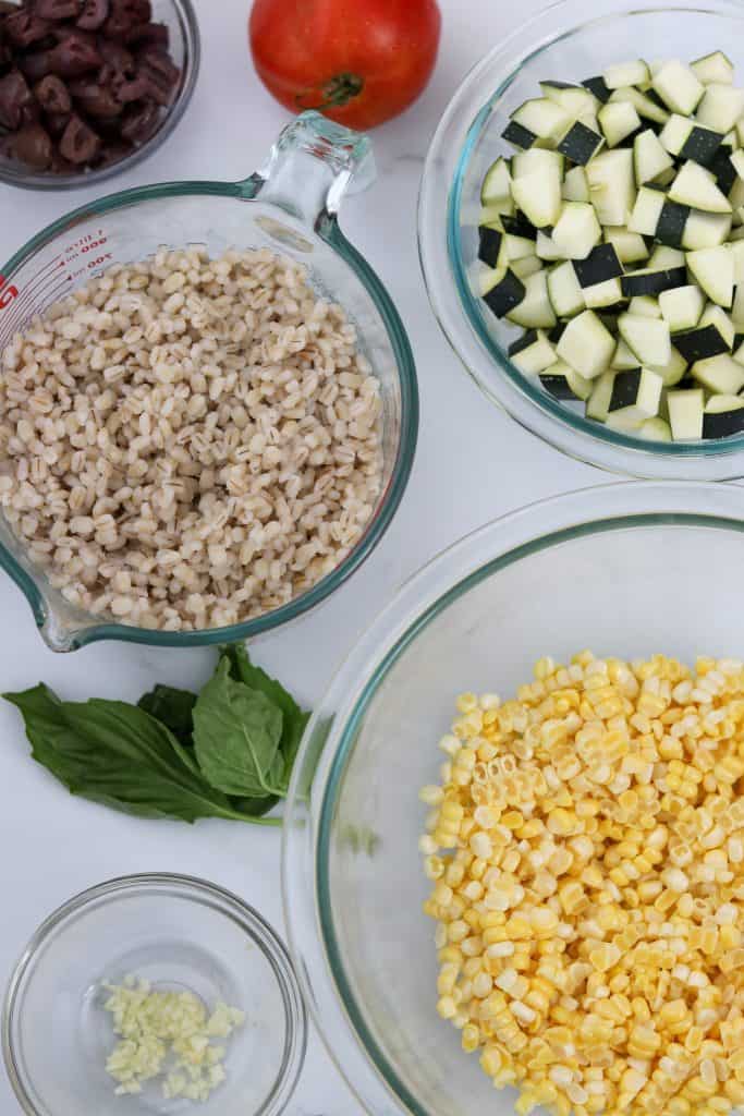 A bowl of barley, a bowl of zucchini and a bowl of corn