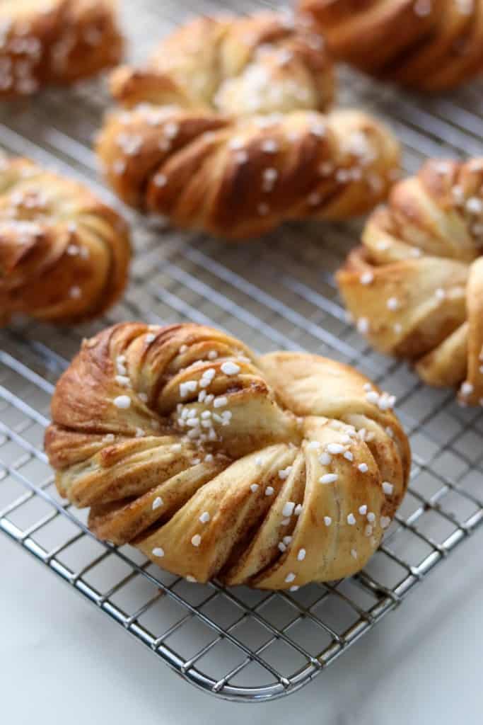 Close up of Swedish cinnamon buns on a cooling rack