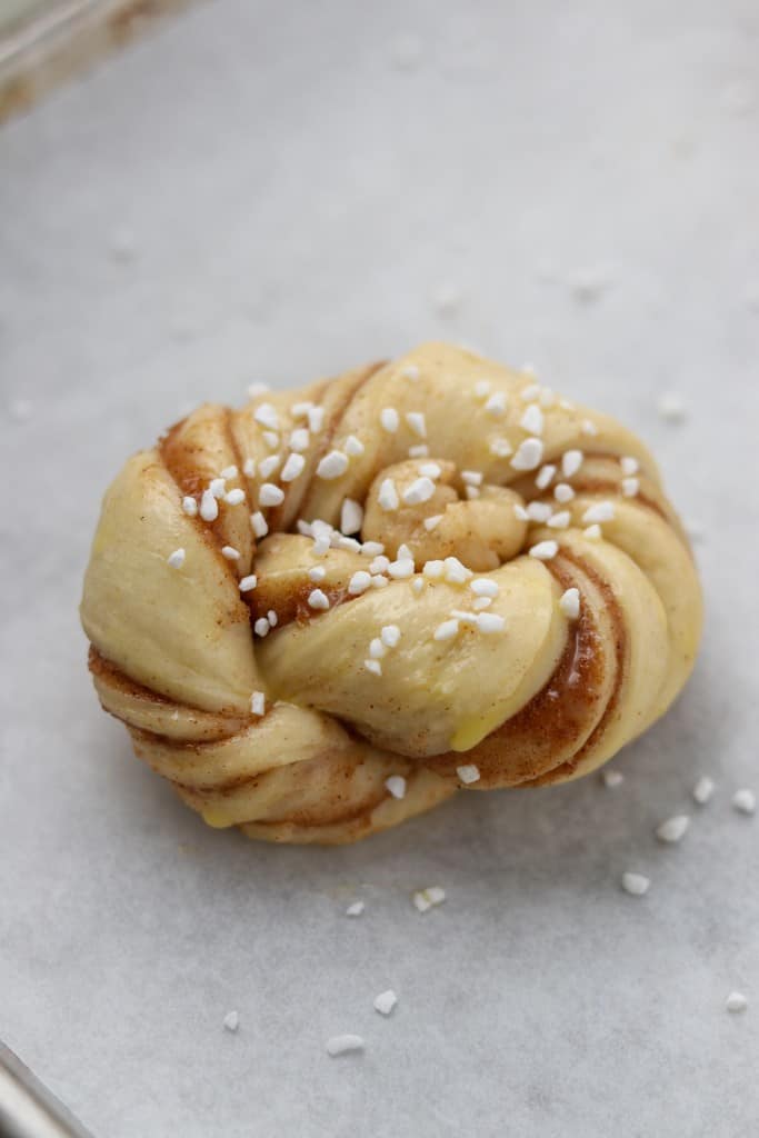 A close up of an unbaked cinnamon bun