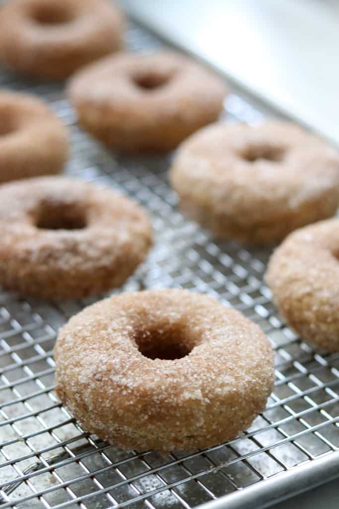 Baked apple donuts on a cooling rack