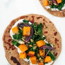 flatbread topped with a cream sauce and roasted vegetables