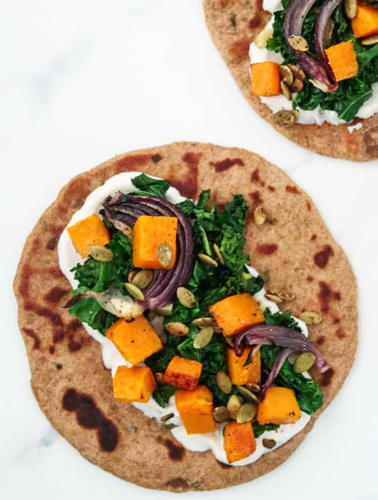 flatbread topped with a cream sauce and roasted vegetables