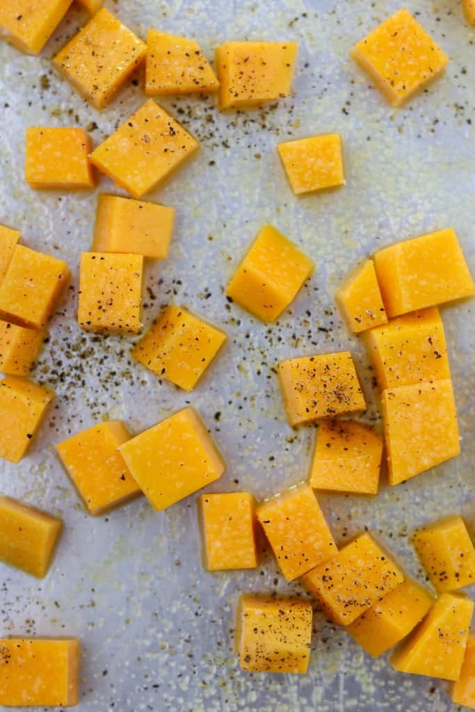 Cubed butternut squash on a sheet pan