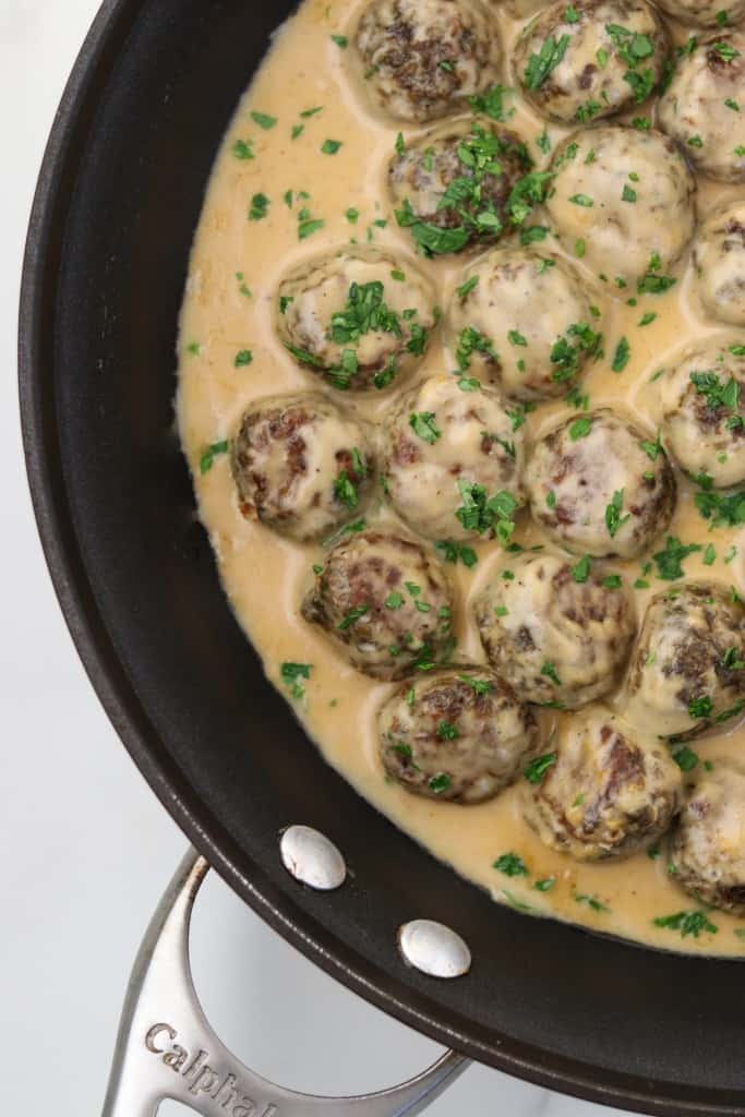 Vegetarian meatballs and cream sauce in a pan