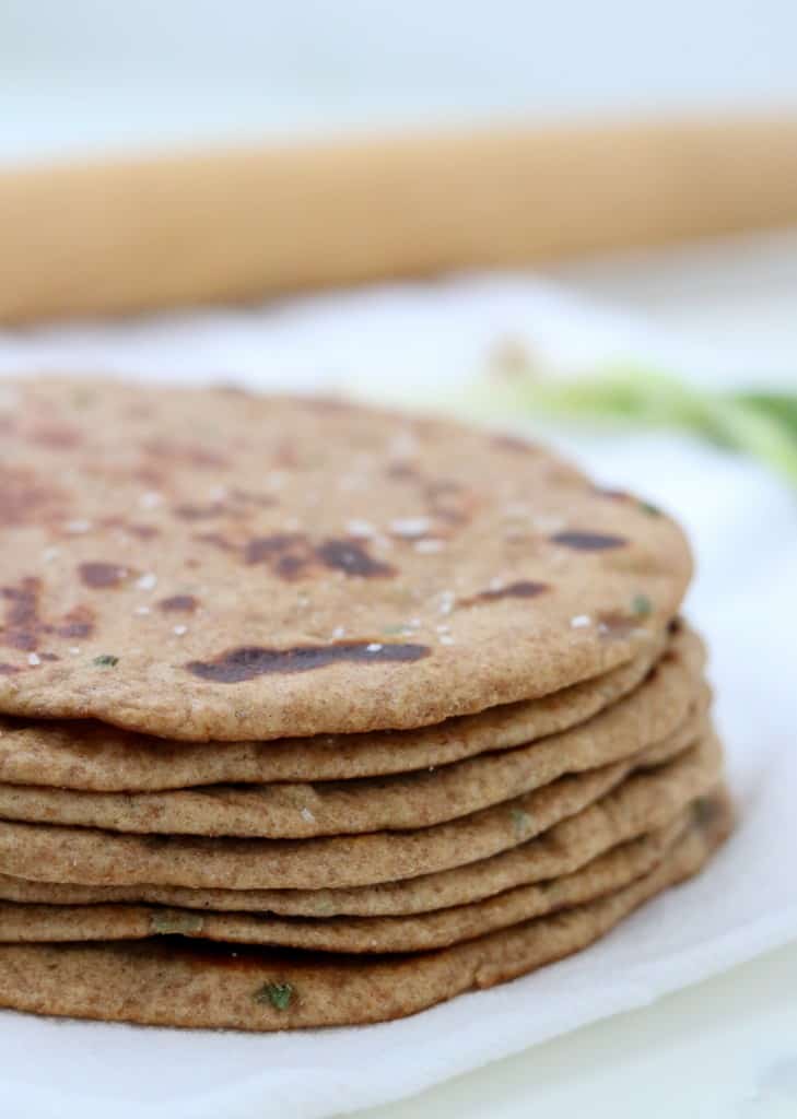 Close up of stack of flatbreads with a rolling pin