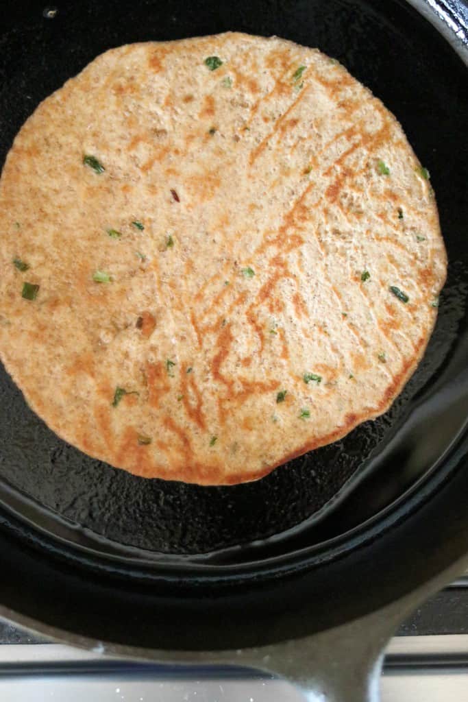 flatbread cooking in a cast iron skillet