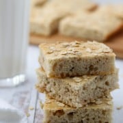 A close up of a stack of Finnish flatbread slices next to a napkin and glass of milk