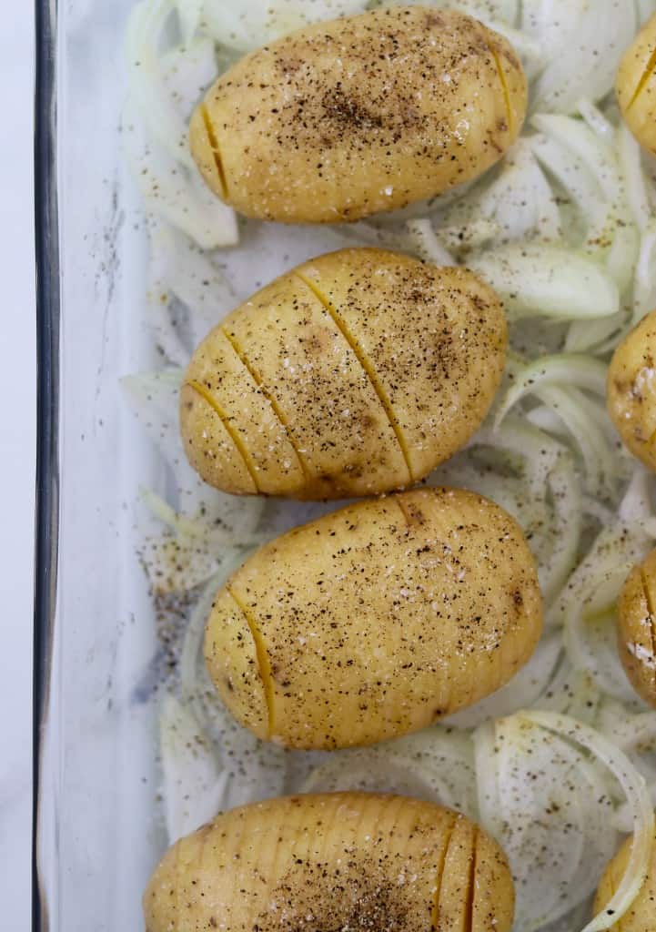 Potatoes and sliced onions in a baking dish