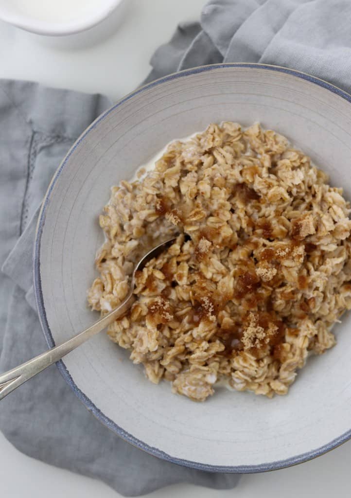 Oatmeal in a bowl with a spoon on a napkin