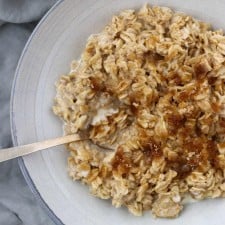 Oatmeal in a bowl with a spoon on a napkin