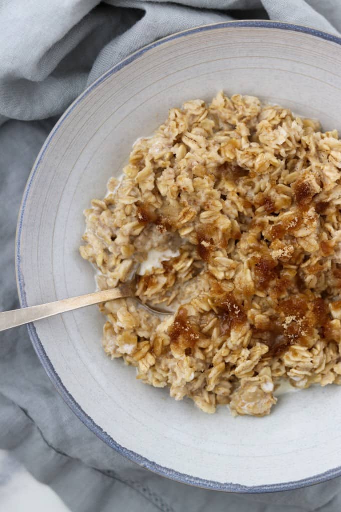 Oatmeal in a bowl with a spoon on a napkin