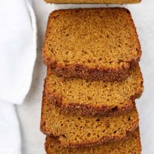 Slices of pumpkin bread next to a towel