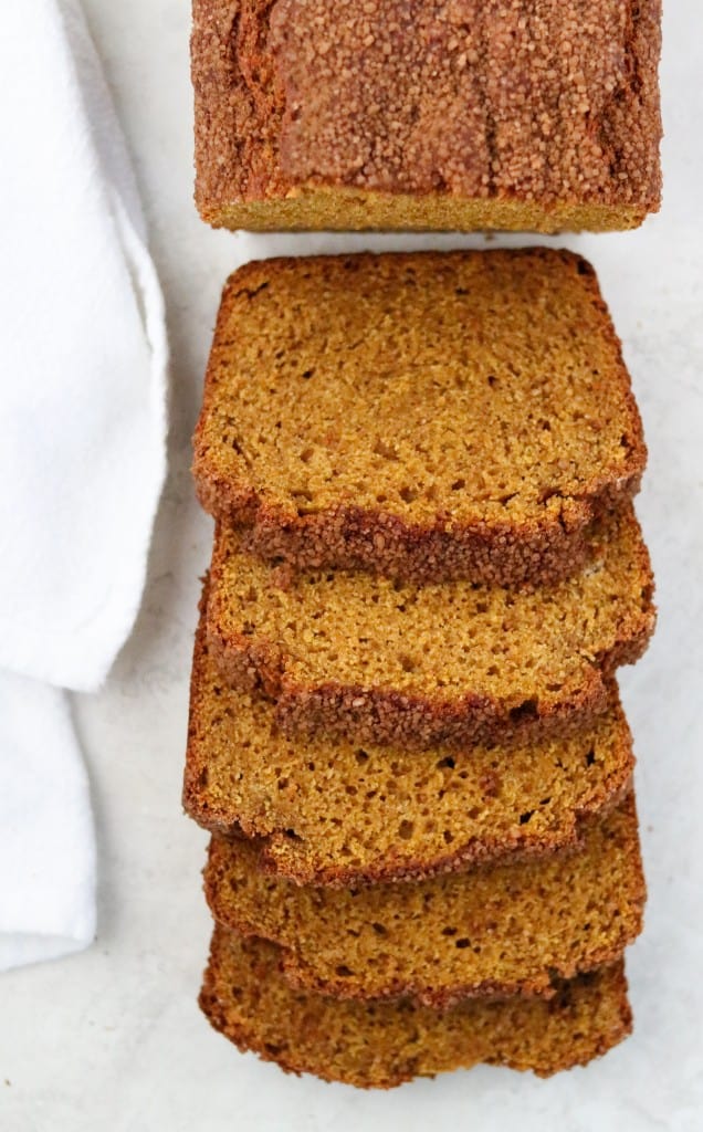 Slices of pumpkin bread next to a towel