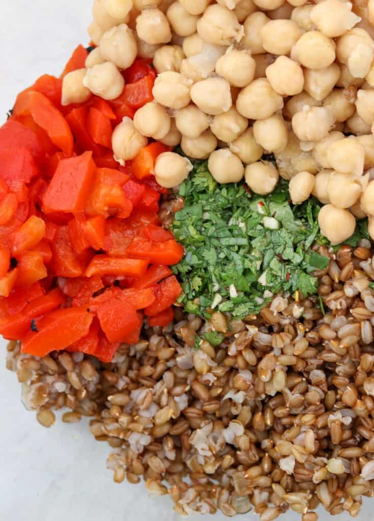 rye berries, red peppers, chickpeas and herbs in a bowl