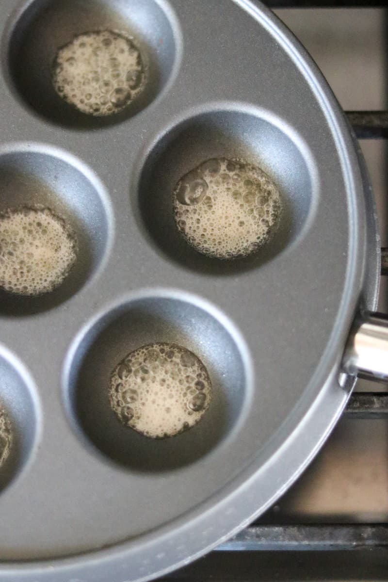 Butter melting in an æbleskiver pan.